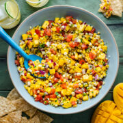 Overhead of the finished mango corn salsa in a blue bowl.