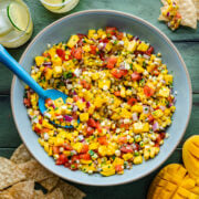 Overhead of the finished mango corn salsa in a blue bowl.