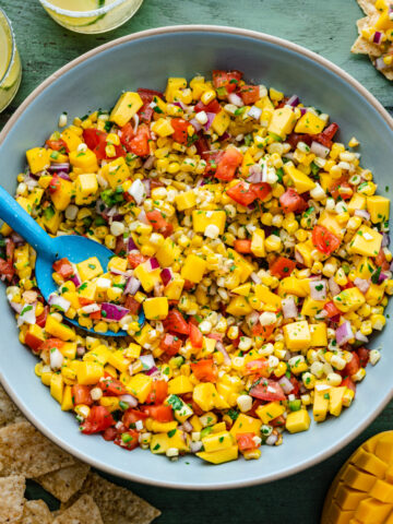 Overhead of the finished mango corn salsa in a blue bowl.