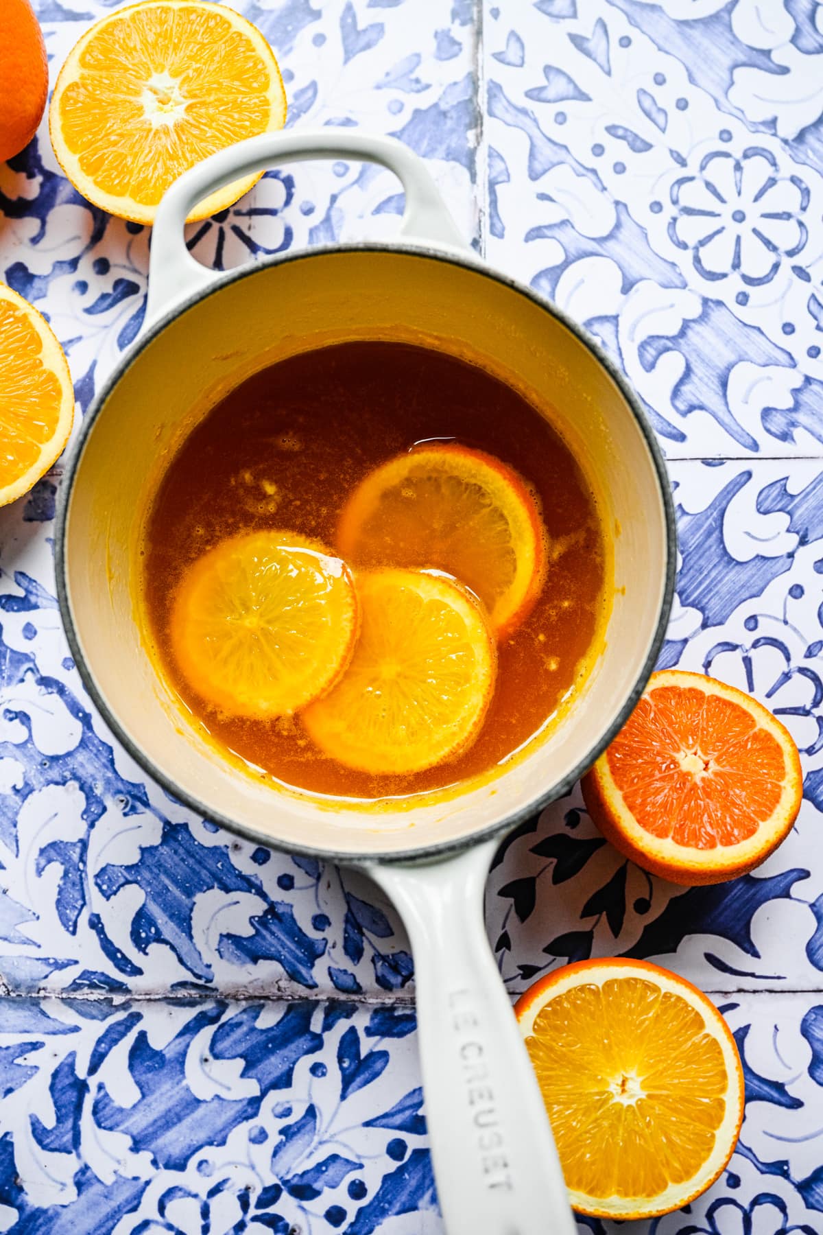 Overhead of the orange simple syrup with orange slices in it.