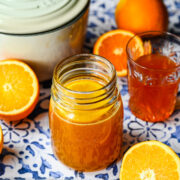 Finished orange simple syrup in a glass jar.