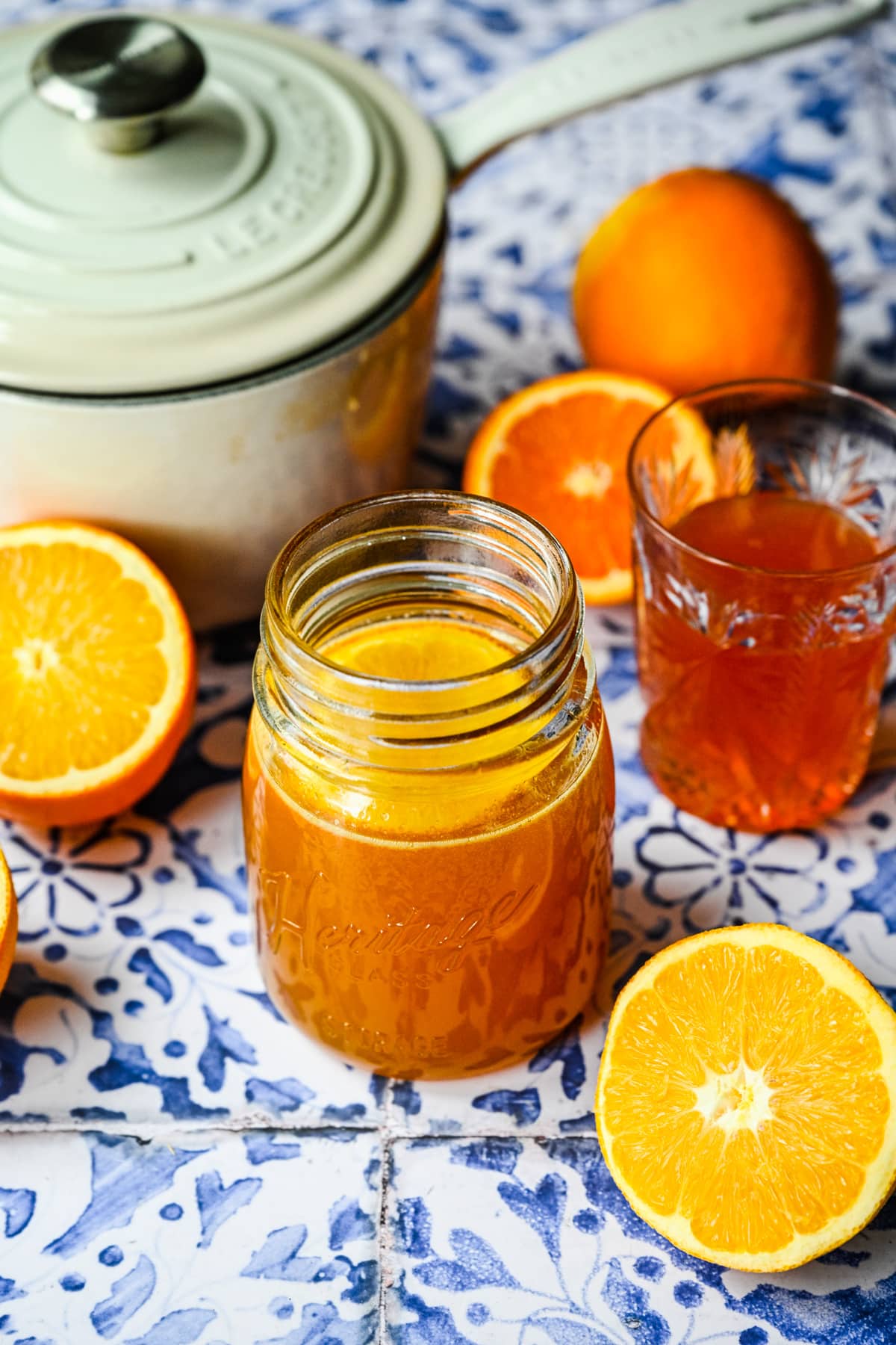 Finished orange simple syrup in a glass jar.