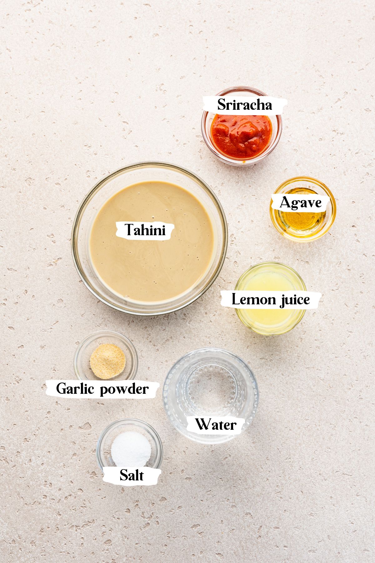 Spiced tahini ingredients including sriracha and lemon juice.