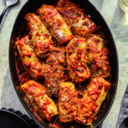 Close up overhead of the finished vegan cabbage rolls in a baking dish.