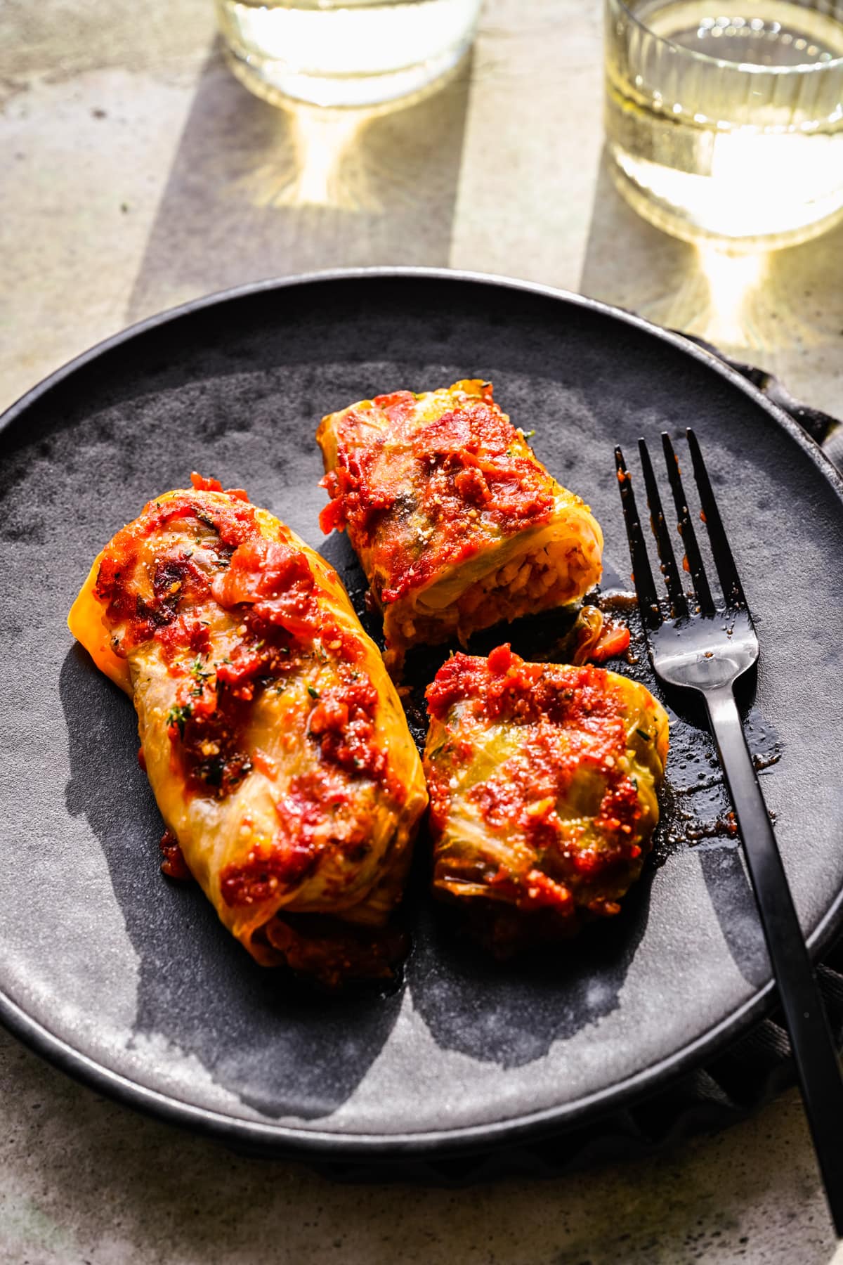 Vegan cabbage rolls plated, showing the interior of one of them.