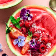Close up overhead of the finished watermelon smoothie bowls with berries on top.