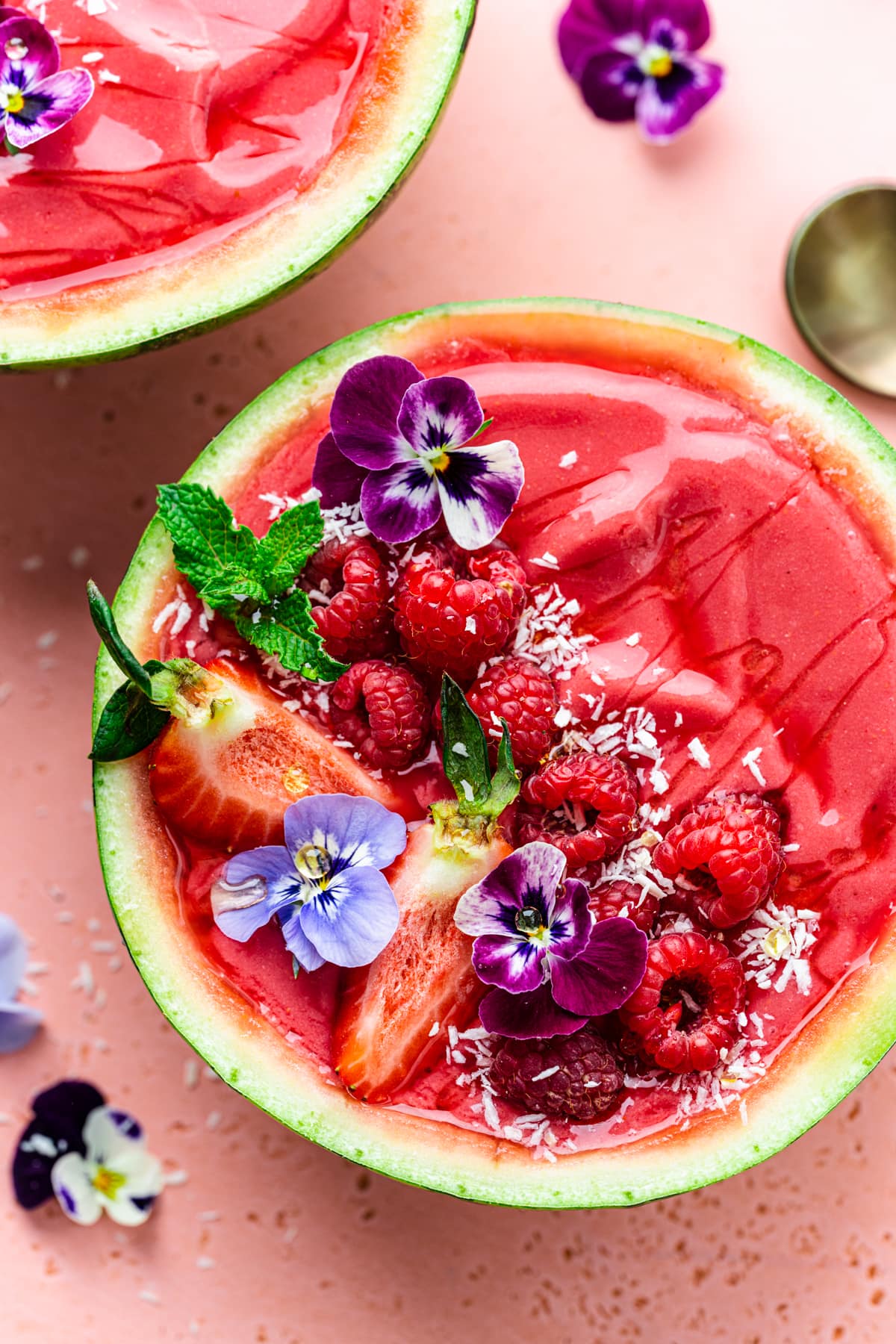 Close up overhead of the finished watermelon smoothie bowls with berries on top.