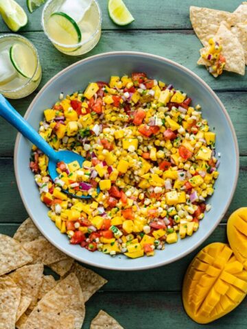 Overhead of the finished mango corn salsa in a blue bowl.