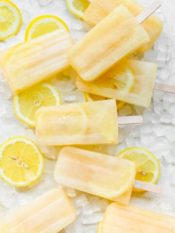 Overhead of the finished lemon popsicles on top of ice.
