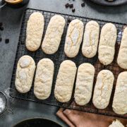 Overhead view of vegan ladyfingers on a wire rack.