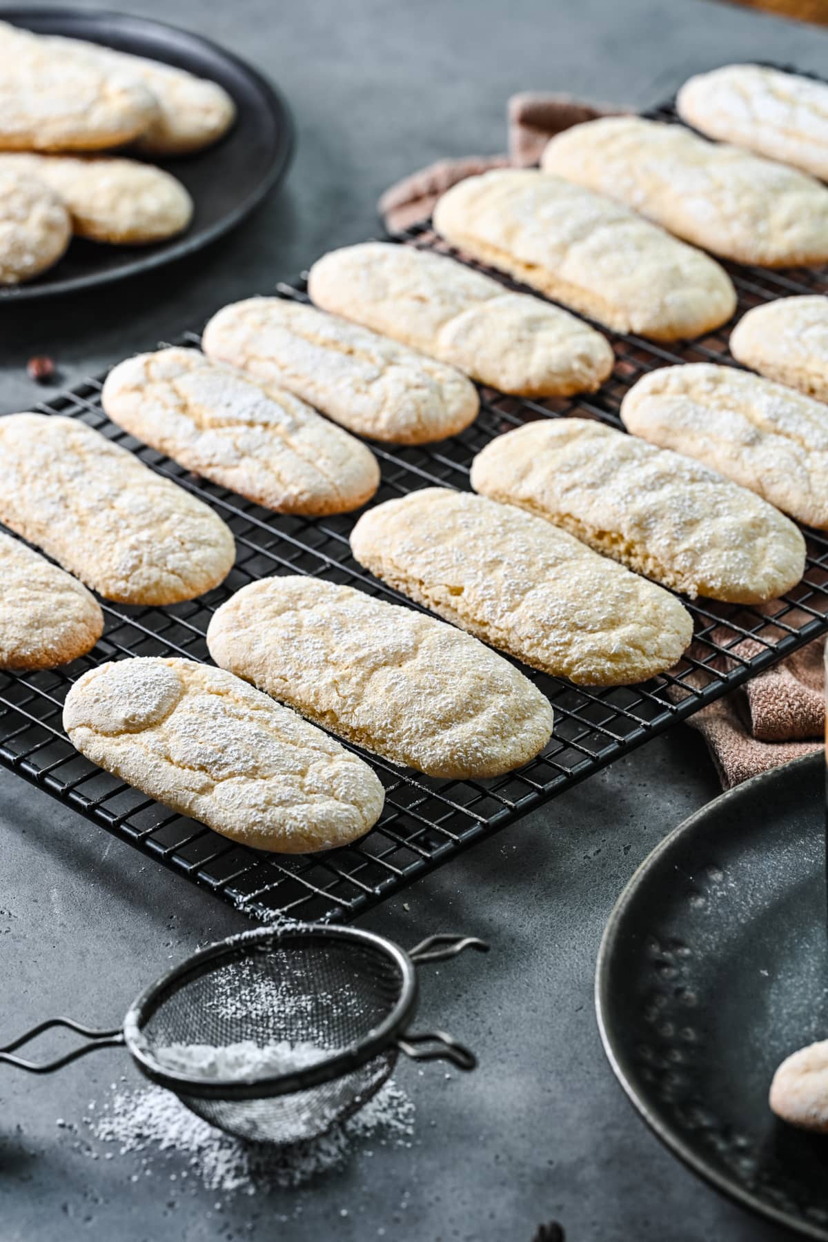 Side view of vegan ladyfingers on a cooling rack.