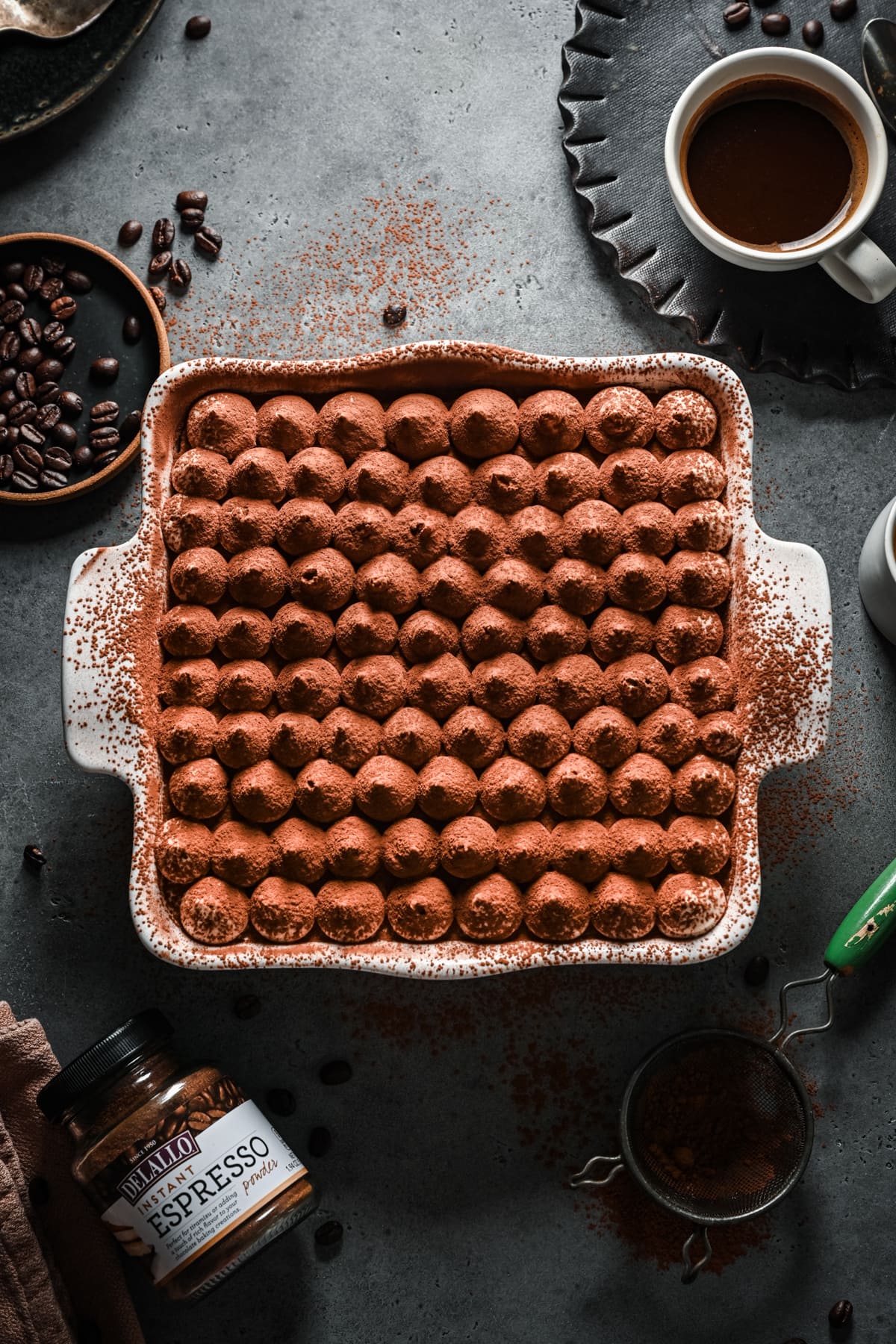 Overhead view of vegan tiramisu in a white baking dish.