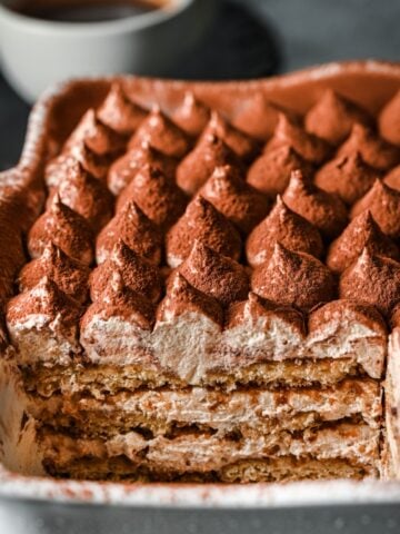 Front view of vegan tiramisu in a baking dish.