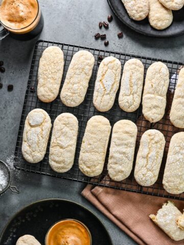 Overhead view of vegan ladyfingers on a wire rack.