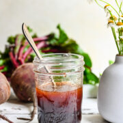 Front view of beet vinaigrette in a mason jar.