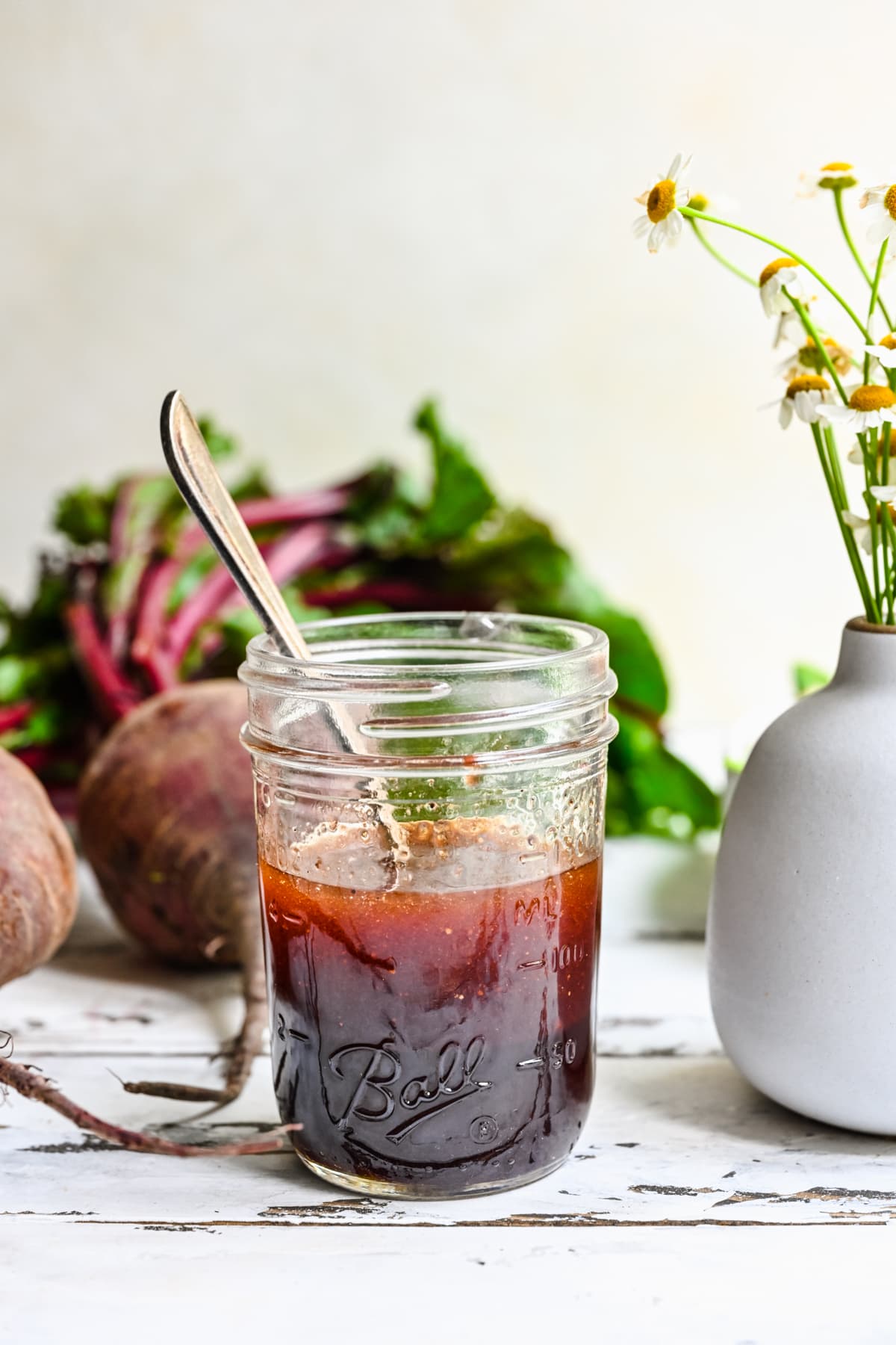 Front view of beet vinaigrette in a mason jar.