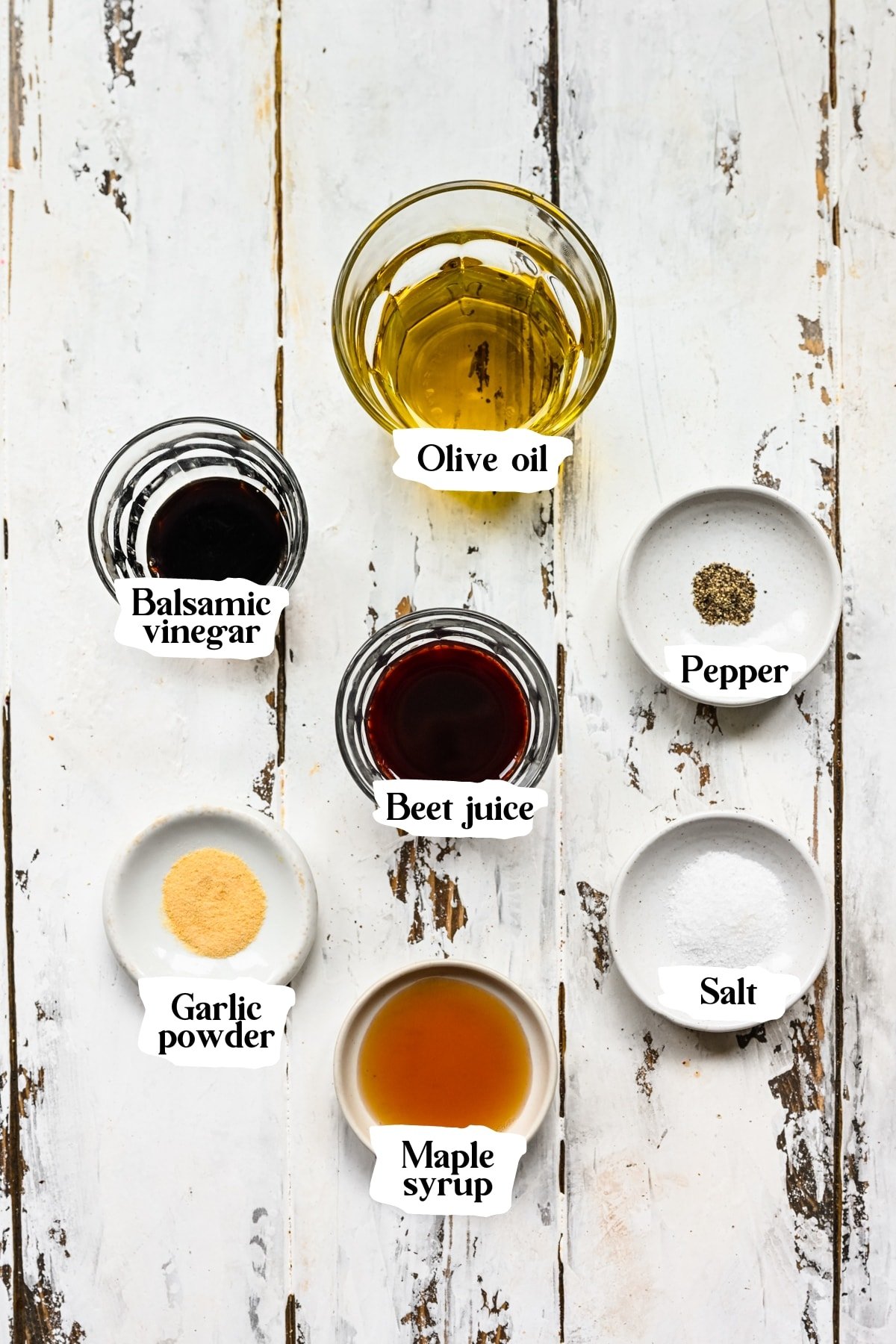 Overhead view of beet vinaigrette ingredients, including balsamic vinegar and beet juice.
