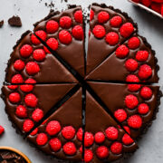 Overhead view of chocolate raspberry tart cut into slices.