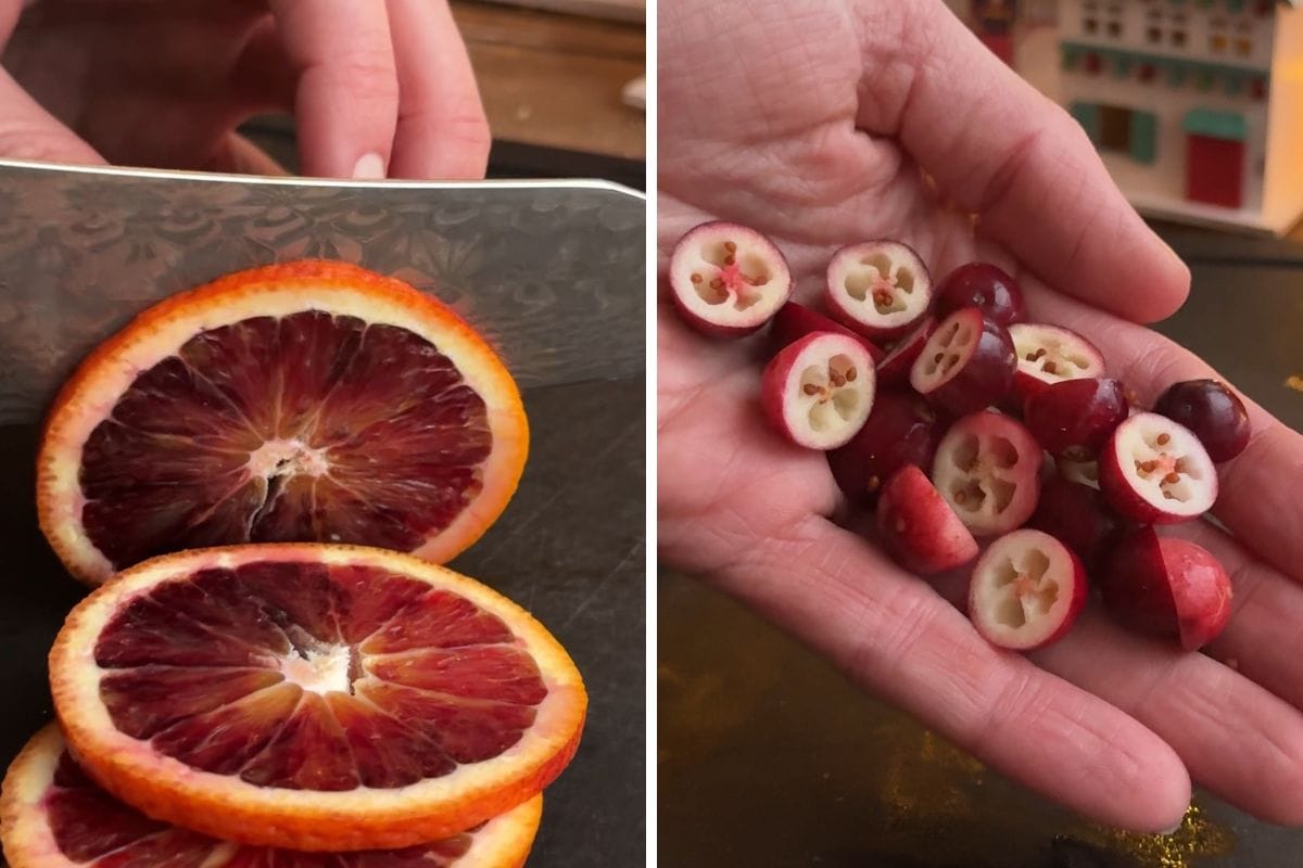 Slicing blood oranges and sliced cranberries in the palm of a hand.