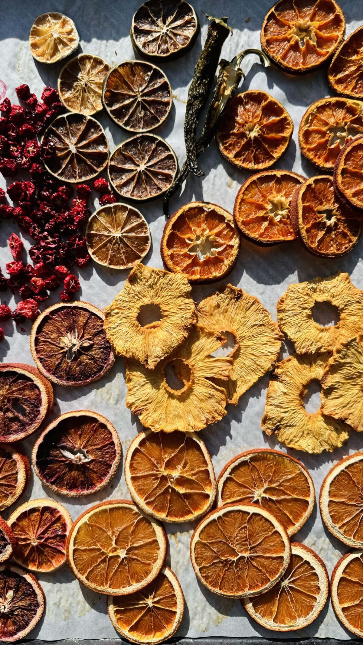 Overhead view of dried fruits on a sheet pan.