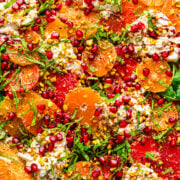 Fresh citrus salad with pomegranate seeds and chopped pistachios, colorful and vibrant Summer recipe.
