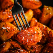 Front view of crispy potato on a fork.