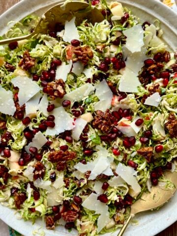 Close up view of shaved brussels sprout salad in a large bowl.