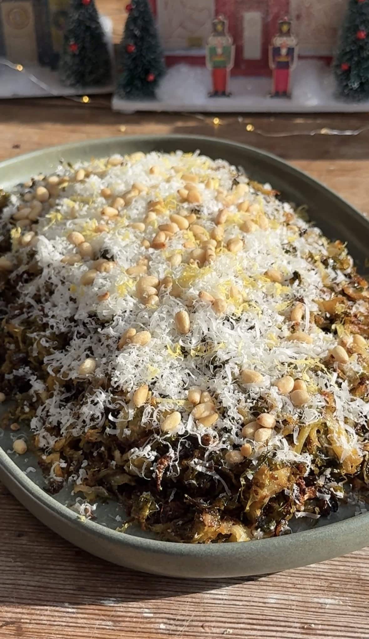 close up view of Roasted shredded brussels sprouts on a platter topped with parmesan.