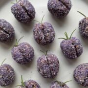 Sugared blackberries with salt and sugar crystals on a white plate.
