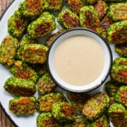 Overhead view of broccoli tots surrounded by honey mustard.