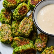 Overhead view of broccoli tots surrounded by honey mustard.