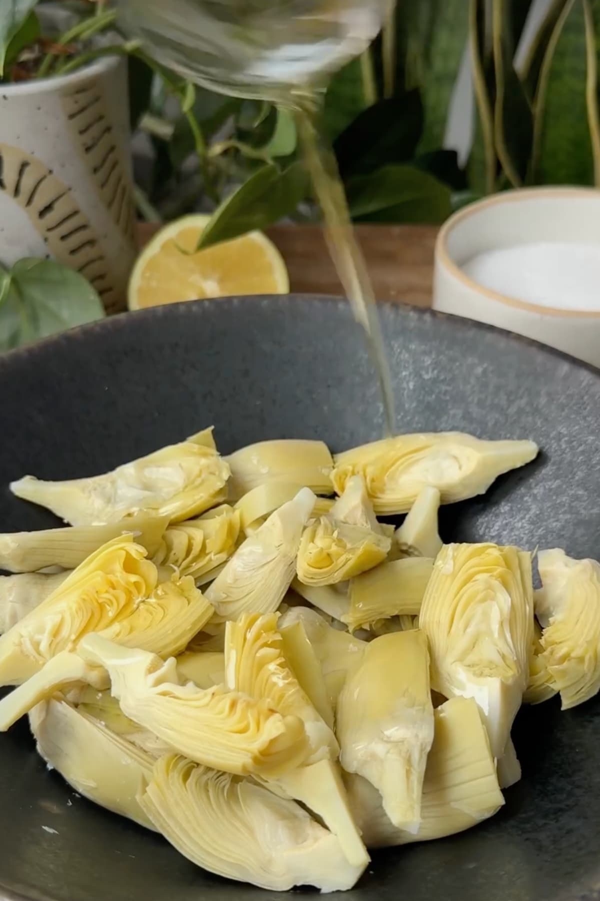 Coating artichokes with olive oil.