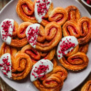Overhead view of raspberry palmiers on a plate.