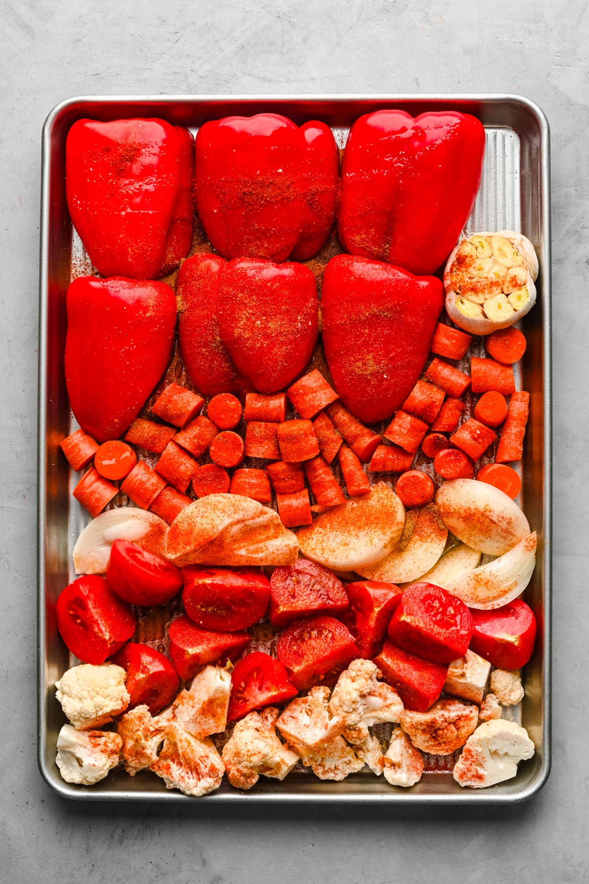 Overhead view of cut vegetables with spices on them.