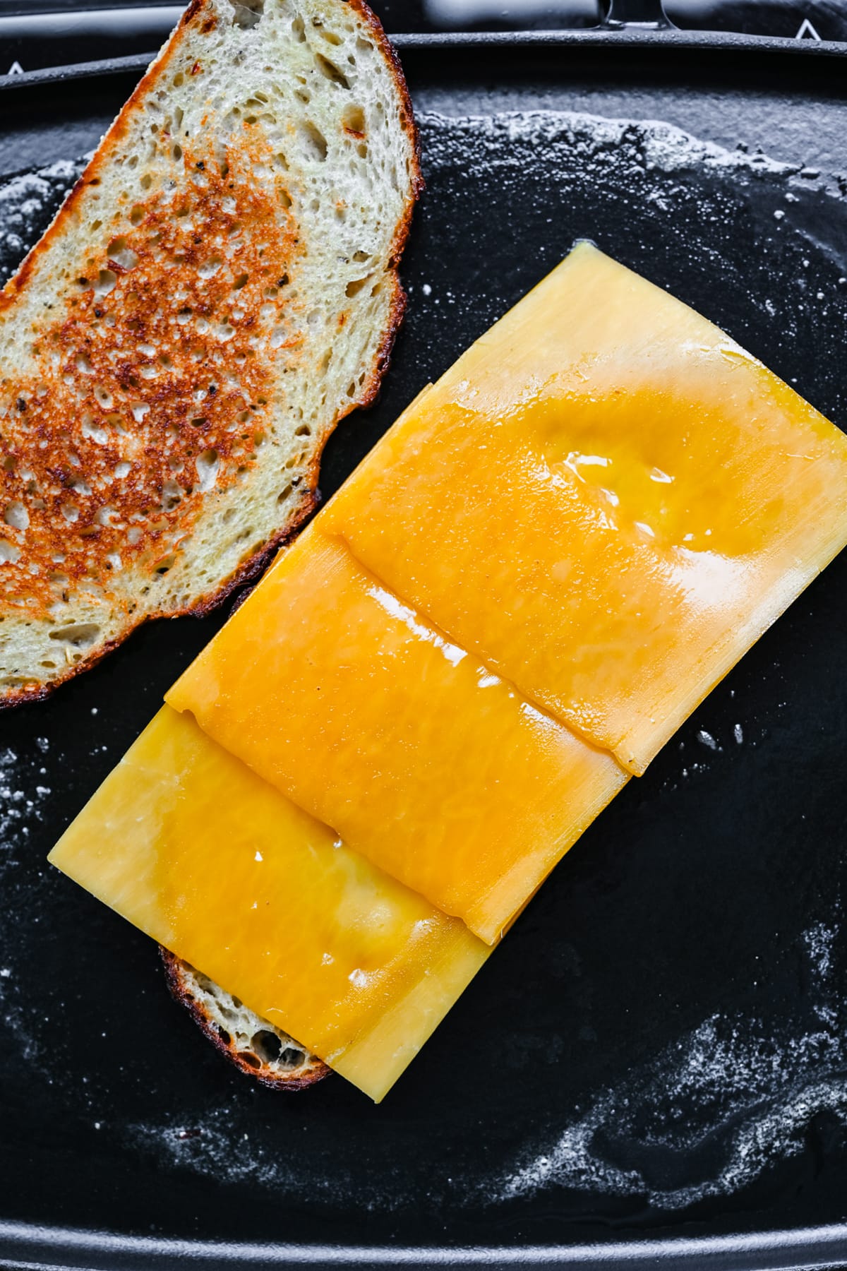 Overhead view of cheese slices on top of bread.