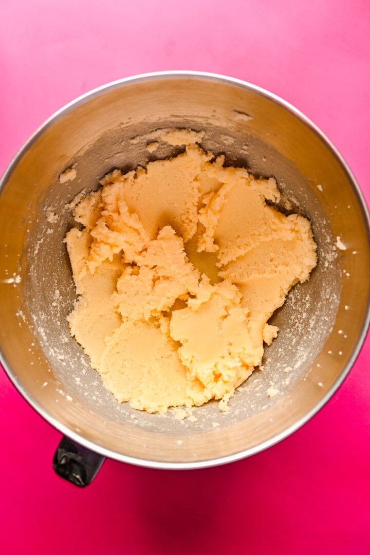 Overhead view of dough in a mixing bowl.