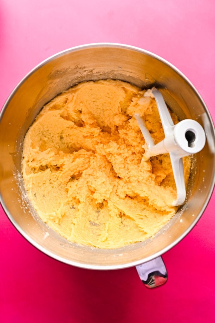 Overhead view of dough in a mixing bowl.