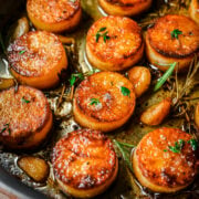 Overhead view of fondant potatoes in a sheet pan.