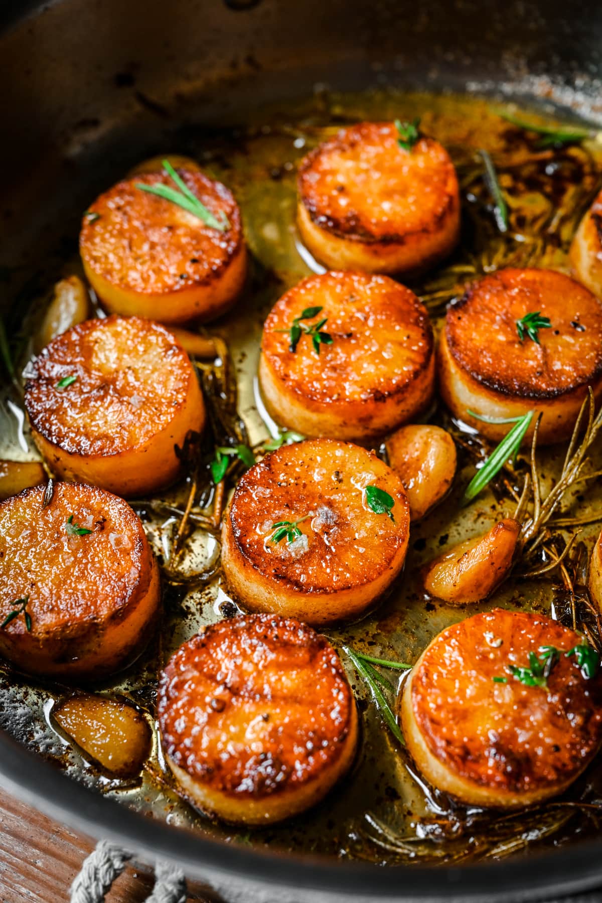 Overhead view of fondant potatoes in a sheet pan.