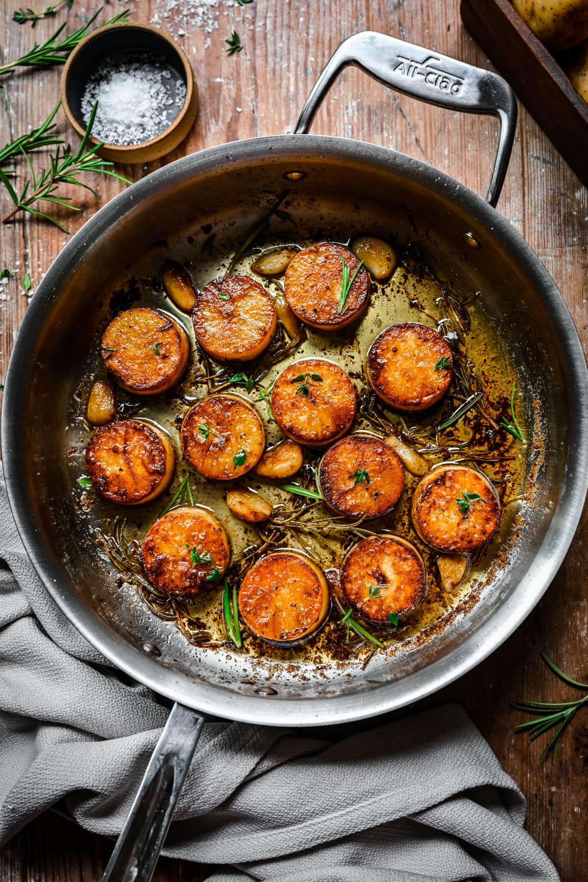 Overhead view of fondant potatoes in a pan.