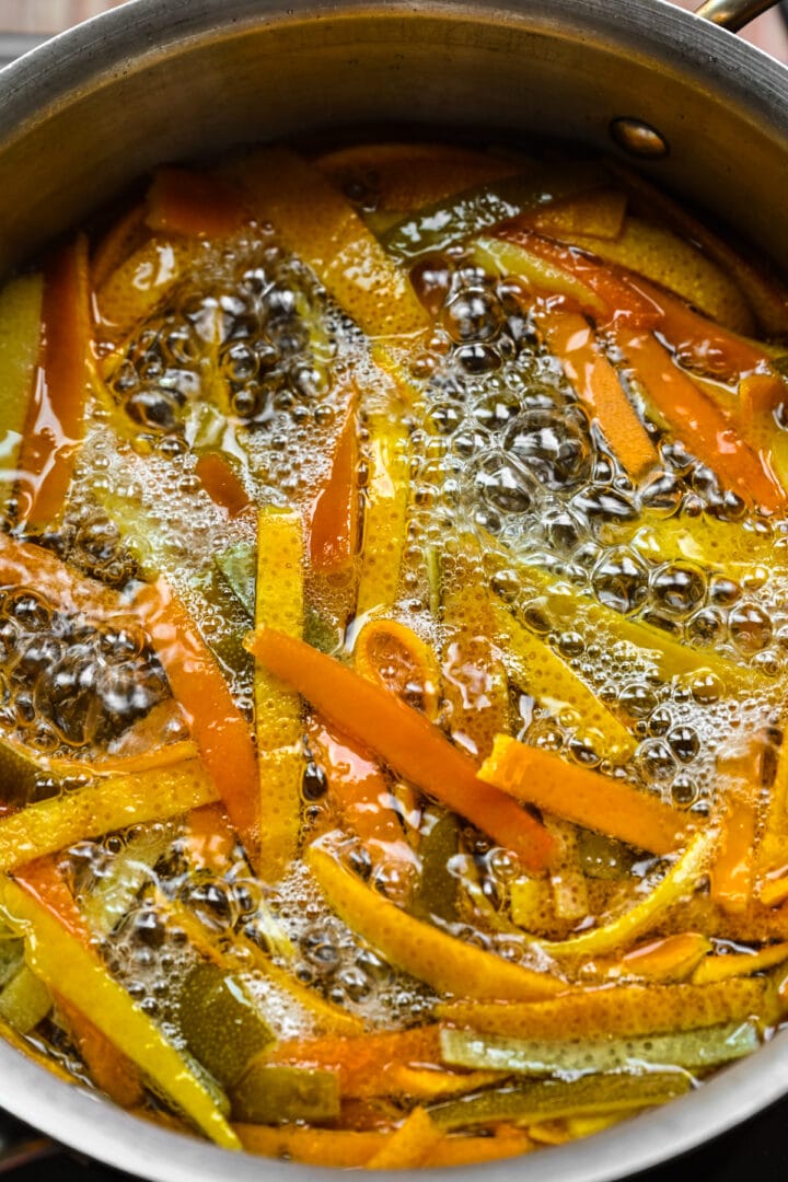 Citrus peels bubbling in sugar.