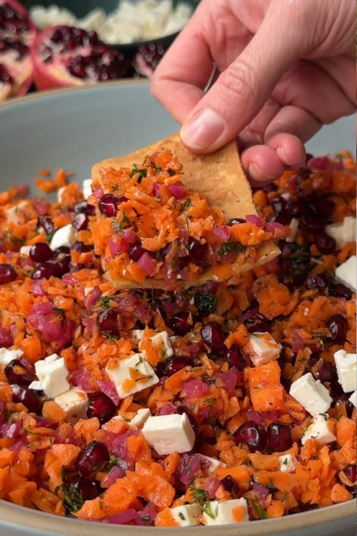 Pita chip dipped into salad.