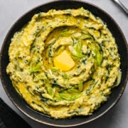 Overhead view of colcannon in a black bowl.