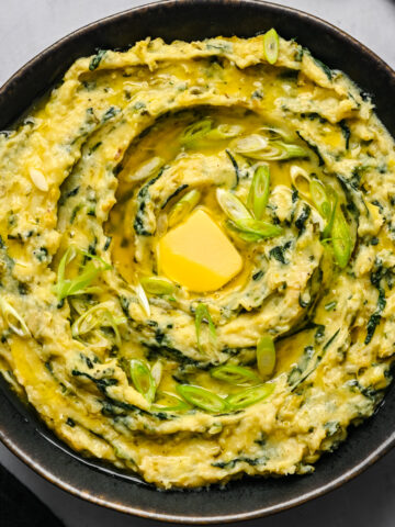 Overhead view of colcannon in a black bowl.