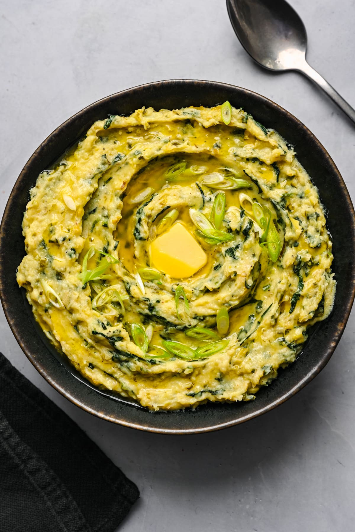 Overhead view of colcannon in a black bowl.