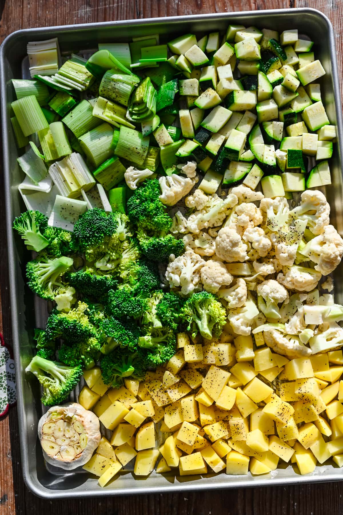 Uncooked vegetables on a sheet pan.