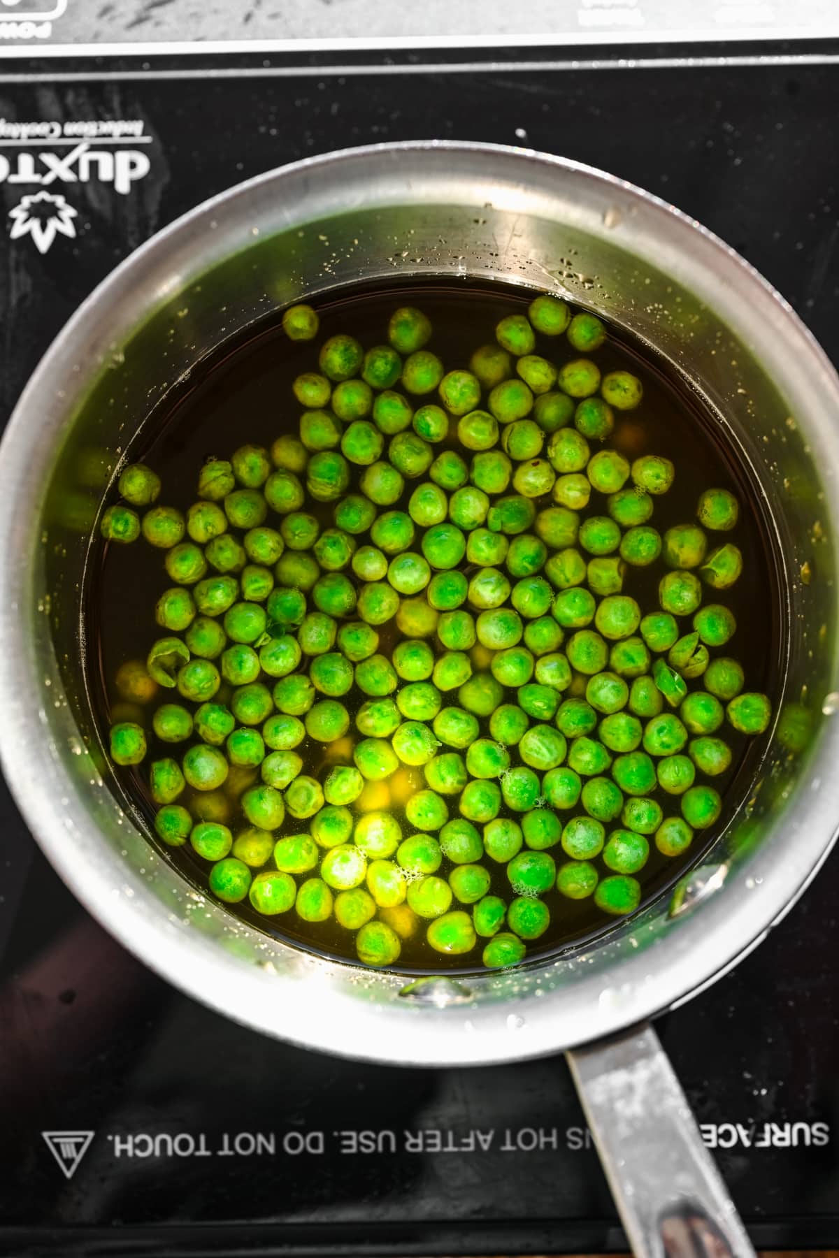 Peas cooking in veggie broth.