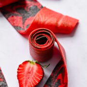 Strawberry fruit roll up on white background.