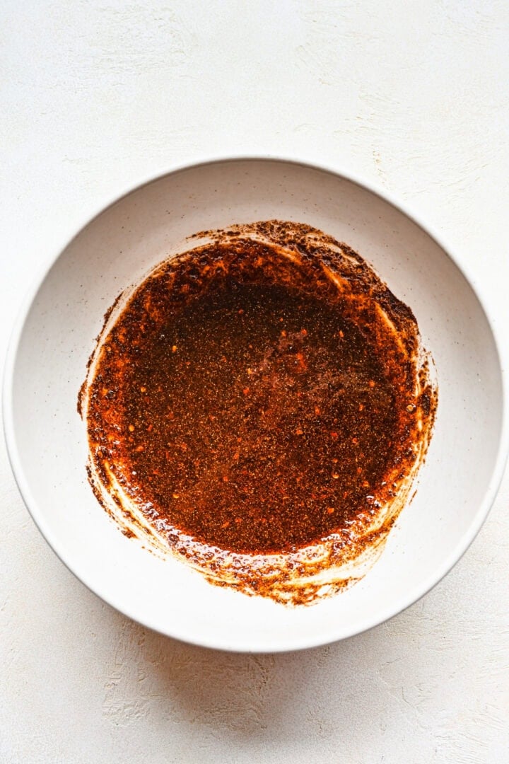 Overhead view of chicken marinade in a bowl.