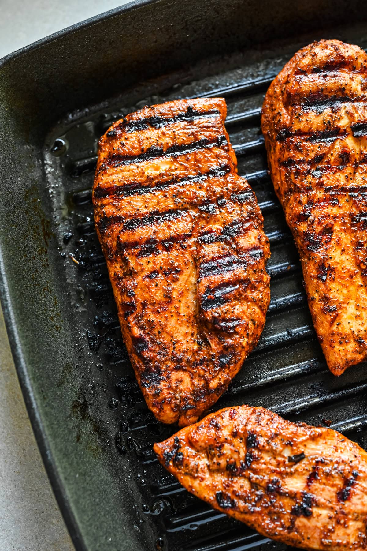 Overhead view of chicken in a grill pan.